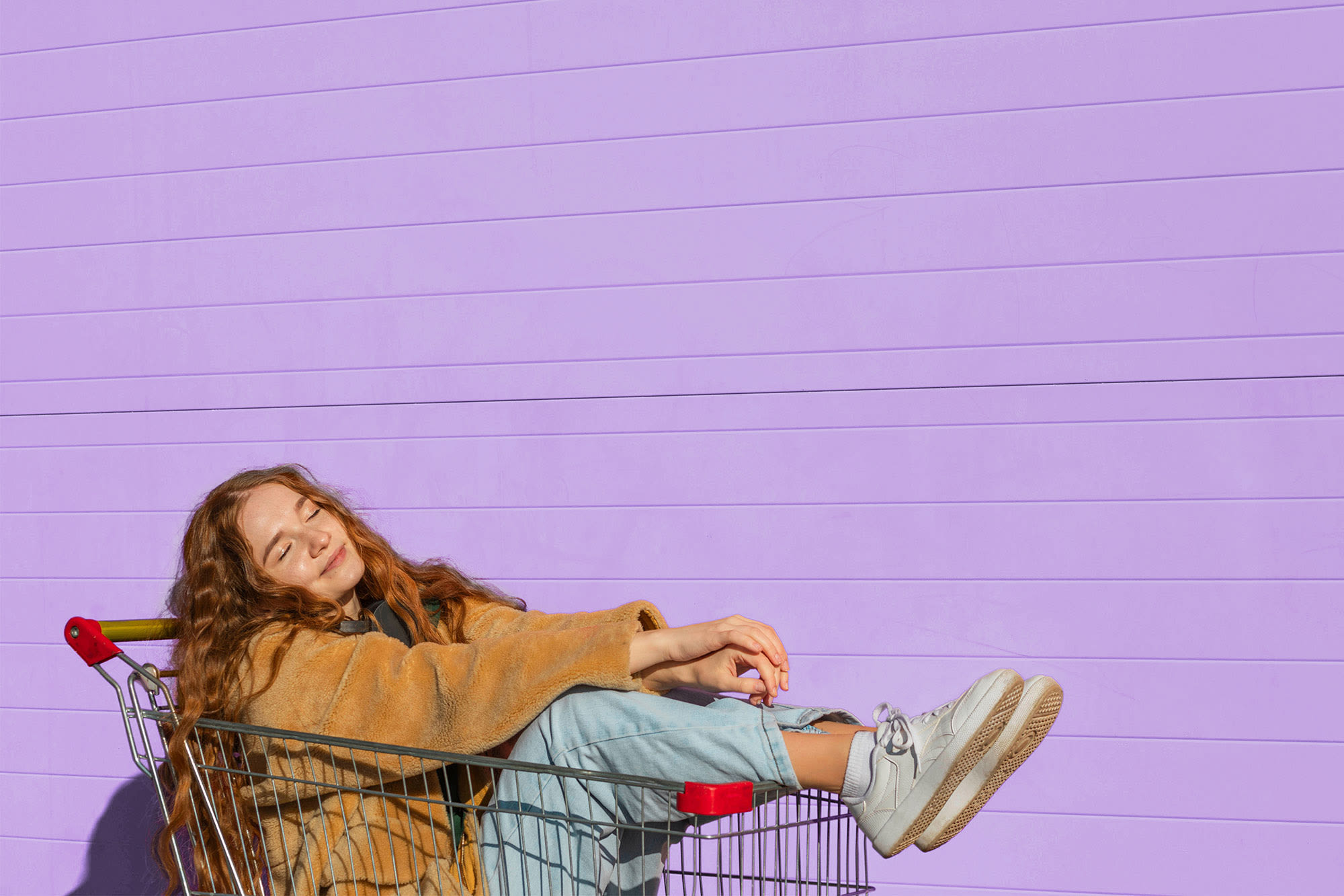 Ženska v nakupovalnem vozičku - finančna svoboda s potrošniškim posojilom banke BKS.